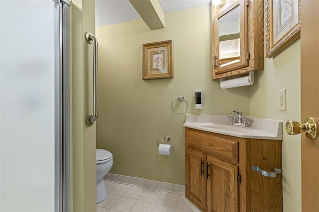 bathroom with tile patterned floors, baseboards, vanity, and toilet