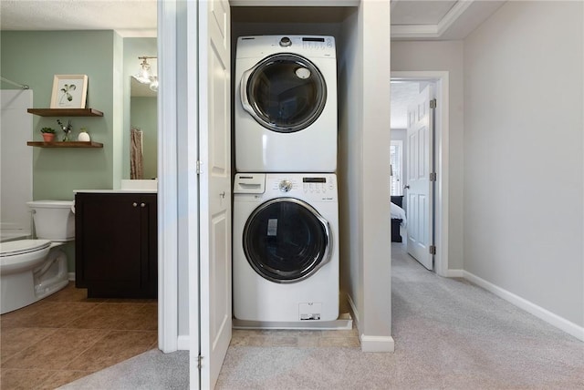 703 Freedom Dr, Collier Twp, PA 15106 - laundry area with stacked washing maching and dryer, carpet floors, and baseboards