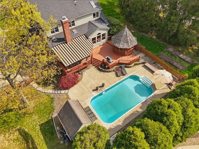 exterior space with a gazebo, a deck, a fenced in pool, a fenced backyard, and a patio