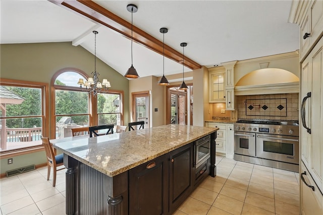 kitchen featuring visible vents, cream cabinets, tasteful backsplash, appliances with stainless steel finishes, and light tile patterned floors