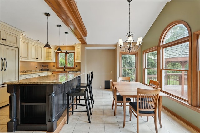 dining area featuring light tile patterned floors and a notable chandelier