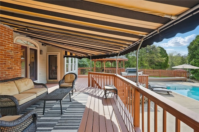 wooden terrace featuring a fenced in pool, outdoor lounge area, and fence