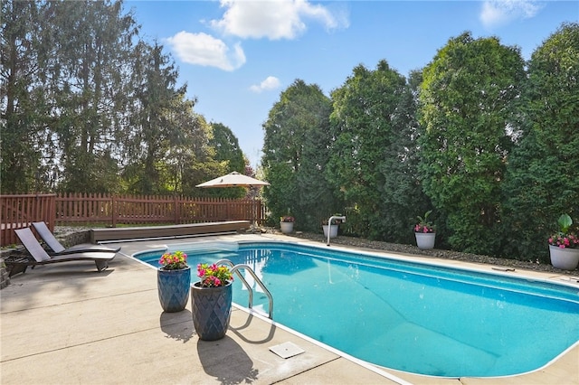 view of swimming pool with a fenced in pool, fence, and a patio