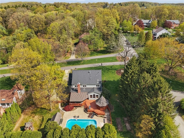 birds eye view of property featuring a view of trees
