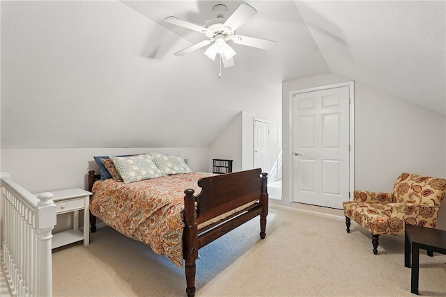 bedroom featuring ceiling fan, lofted ceiling, and light carpet