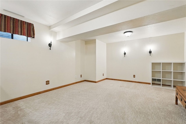 basement featuring baseboards and light colored carpet