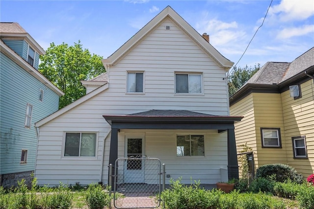 25 Scotia St, Ingram, PA 15205 - view of front facade with a gate and a chimney
