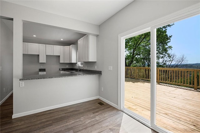 25 Scotia St, Ingram, PA 15205 - kitchen with white cabinets, a sink, baseboards, wood finished floors, and visible vents
