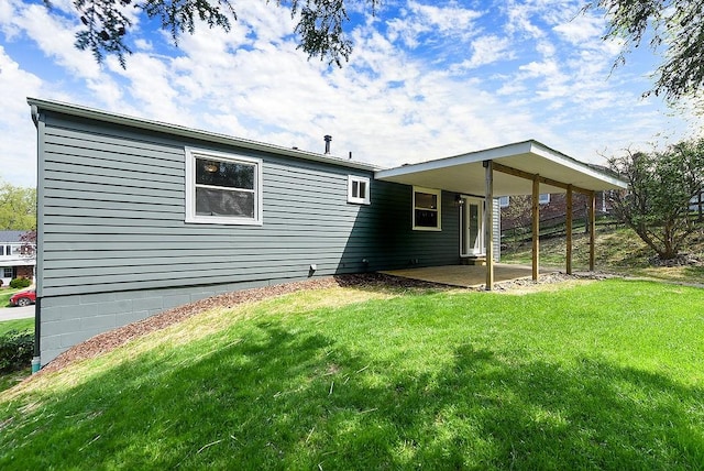 back of property with a patio and a yard