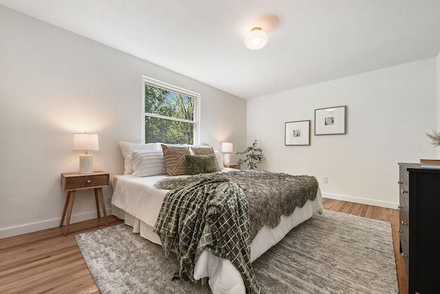 bedroom featuring light wood-type flooring and baseboards