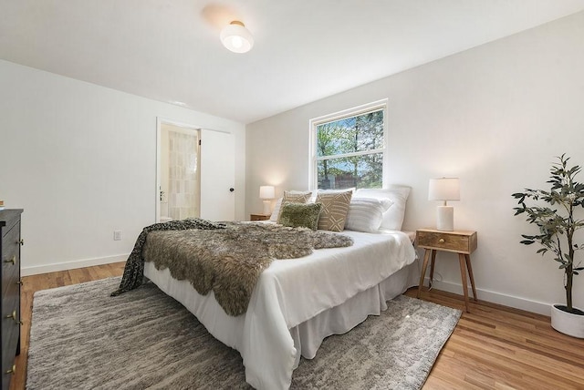 bedroom featuring baseboards and wood finished floors