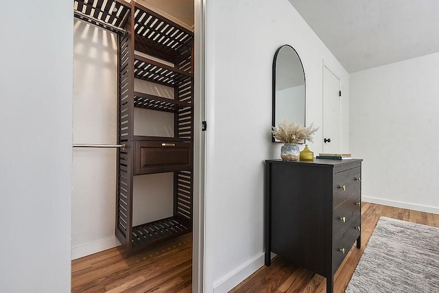 interior space with baseboards and wood finished floors