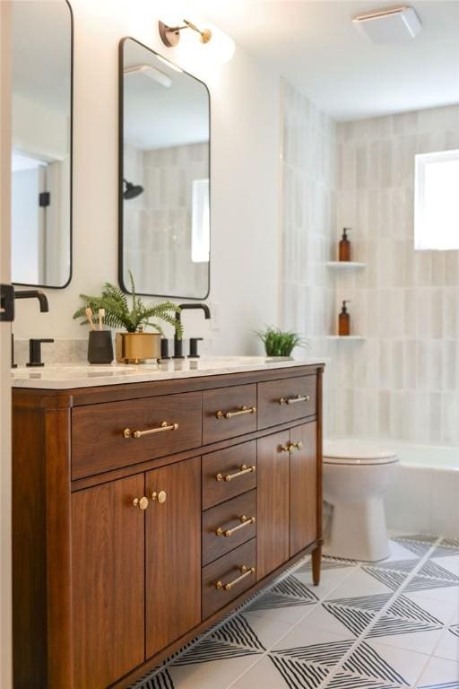 bathroom with toilet, tile patterned floors, and vanity