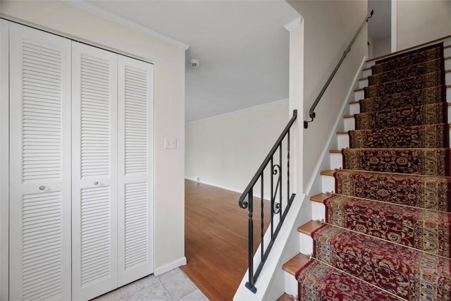 stairs with baseboards and tile patterned floors