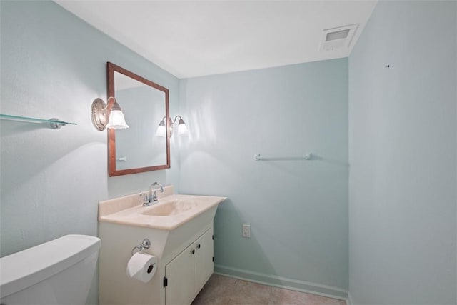 half bath with vanity, baseboards, toilet, and visible vents
