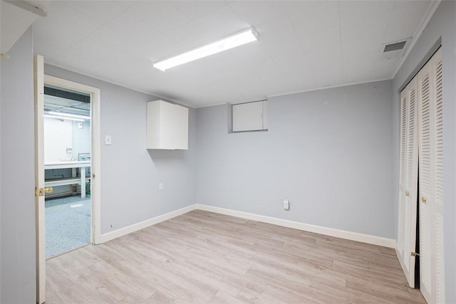interior space with a closet, baseboards, and light wood-type flooring