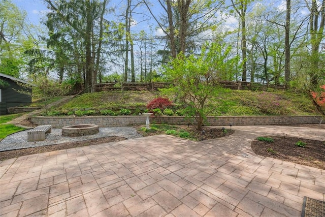 view of patio with a fenced backyard and a fire pit