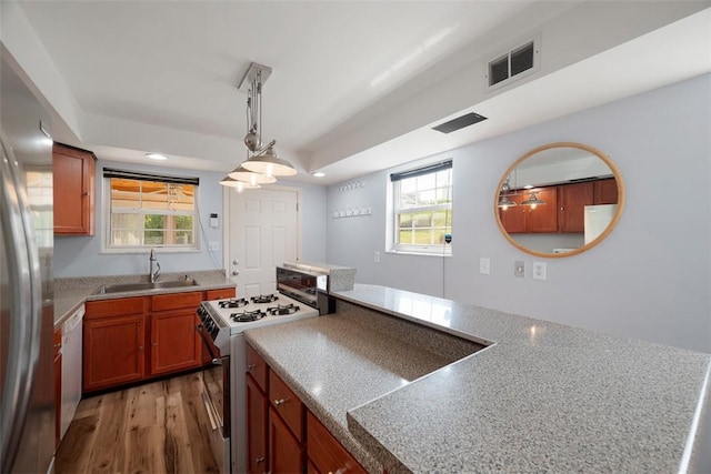 1928 Shamokin, South Side, PA 15203 - kitchen with decorative light fixtures, visible vents, a sink, light wood finished floors, and white appliances
