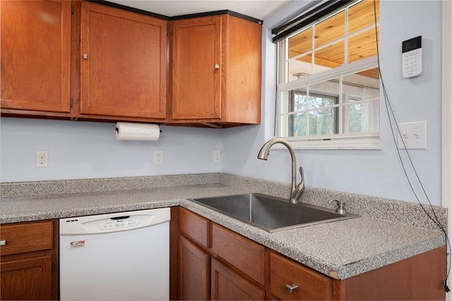 1928 Shamokin, South Side, PA 15203 - kitchen featuring white dishwasher, light countertops, brown cabinets, and a sink