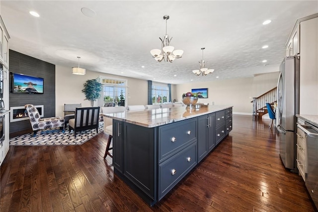1043 Blackthorne Dr, Penn Twp Wml, PA 15644 - kitchen with a center island, freestanding refrigerator, dark wood-style flooring, and a notable chandelier