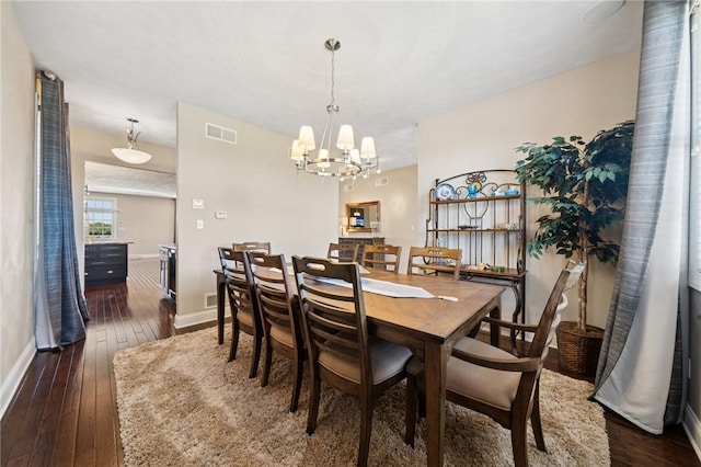 1043 Blackthorne Dr, Penn Twp Wml, PA 15644 - dining area featuring a chandelier, baseboards, visible vents, and dark wood-type flooring