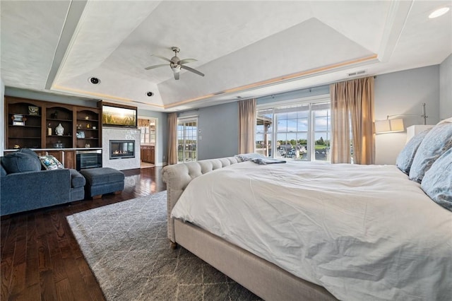 1043 Blackthorne Dr, Penn Twp Wml, PA 15644 - bedroom featuring a glass covered fireplace, hardwood / wood-style floors, ceiling fan, recessed lighting, and a raised ceiling