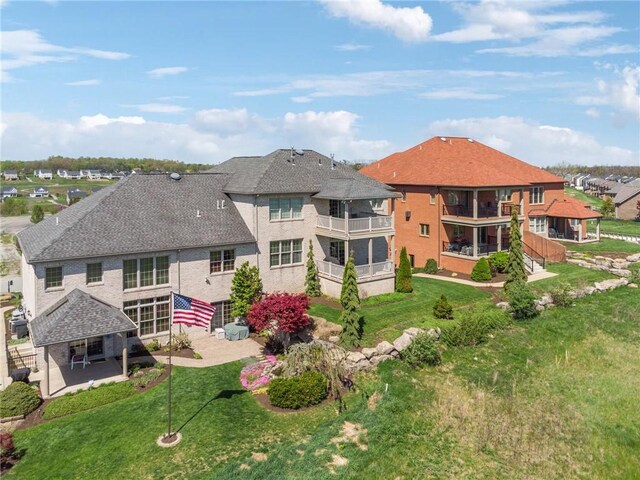 1043 Blackthorne Dr, Penn Twp Wml, PA 15644 - rear view of property with a yard, a residential view, a balcony, and a patio area
