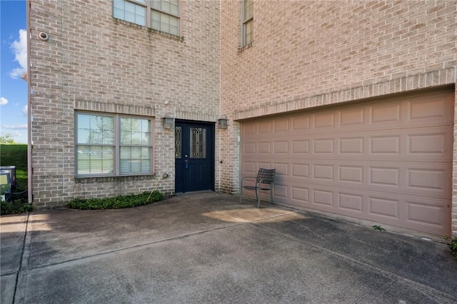 1043 Blackthorne Dr, Penn Twp Wml, PA 15644 - doorway to property with a garage, driveway, and brick siding