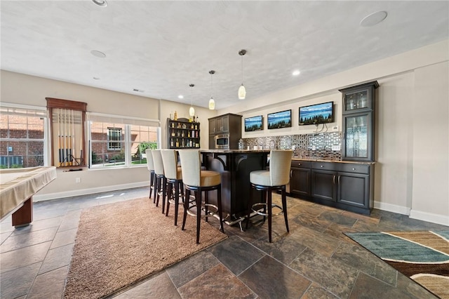 1043 Blackthorne Dr, Penn Twp Wml, PA 15644 - bar featuring decorative backsplash, baseboards, indoor wet bar, recessed lighting, and stone tile floors