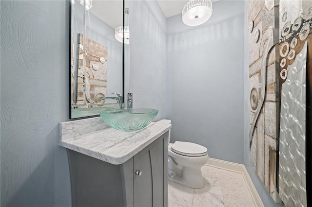 1043 Blackthorne Dr, Penn Twp Wml, PA 15644 - half bathroom with toilet, baseboards, marble finish floor, and vanity