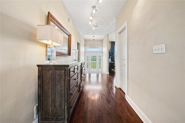 1043 Blackthorne Dr, Penn Twp Wml, PA 15644 - hallway featuring dark wood-style flooring, rail lighting, a chandelier, baseboards, and visible vents