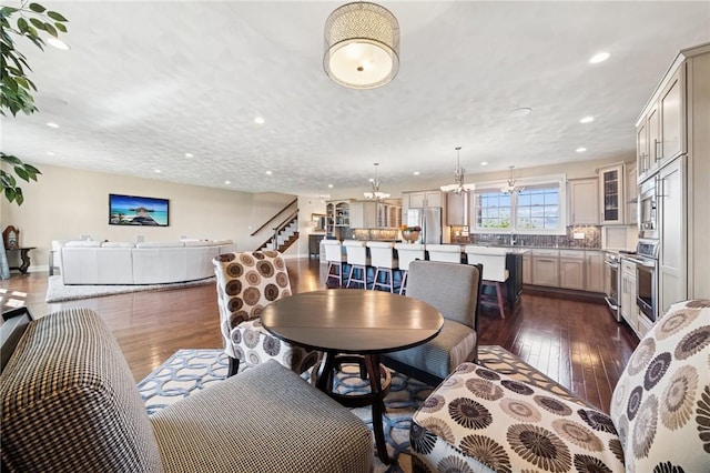 1043 Blackthorne Dr, Penn Twp Wml, PA 15644 - living room with an inviting chandelier, recessed lighting, dark wood-style flooring, and stairs
