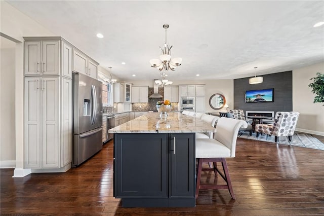 1043 Blackthorne Dr, Penn Twp Wml, PA 15644 - kitchen featuring baseboards, stainless steel appliances, dark wood finished floors, and wall chimney exhaust hood