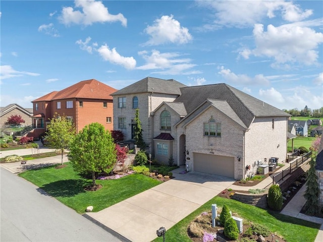 1043 Blackthorne Dr, Penn Twp Wml, PA 15644 - french country home featuring brick siding, a garage, driveway, and a front yard