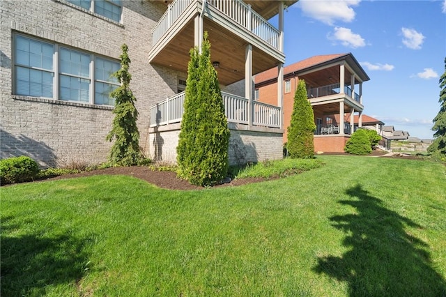 1043 Blackthorne Dr, Penn Twp Wml, PA 15644 - view of property exterior featuring a yard, brick siding, and a balcony
