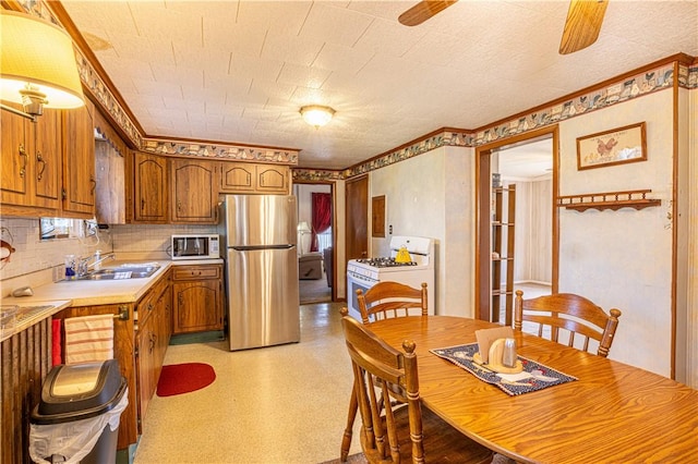 14 Cedar St, Masontown, PA 15461 - kitchen with a sink, light countertops, freestanding refrigerator, a ceiling fan, and white range with gas cooktop