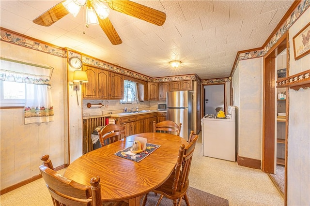 14 Cedar St, Masontown, PA 15461 - dining area with washer / dryer, baseboards, ornamental molding, and a ceiling fan