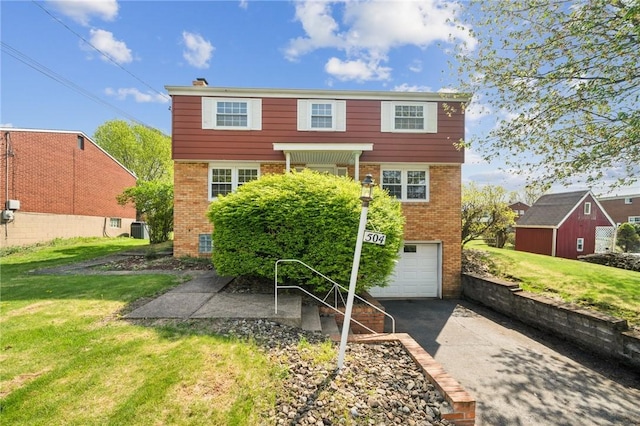 rear view of house with a lawn, driveway, central AC, and brick siding