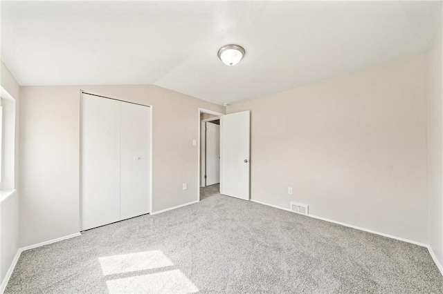 unfurnished bedroom with baseboards, carpet, and visible vents