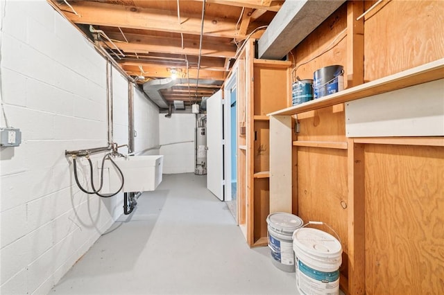 unfinished basement featuring water heater and concrete block wall