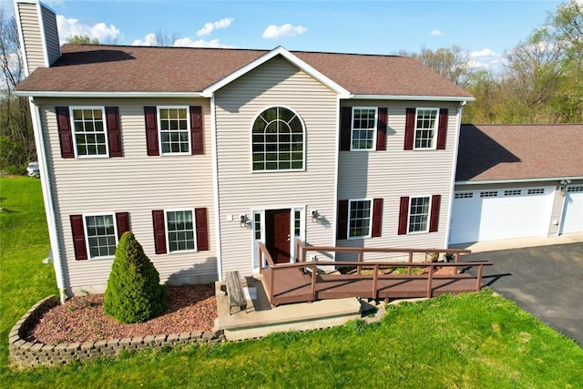 91 Green Manor Dr, Summit Twp But, PA 16002 - colonial inspired home featuring aphalt driveway, a chimney, a deck, a garage, and a front lawn