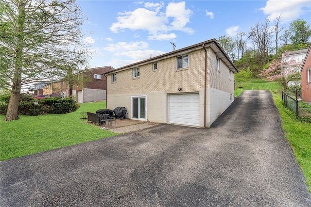 935 Broglie, South Park, PA 15236 - rear view of house featuring driveway, a lawn, a garage, brick siding, and fence