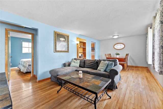 935 Broglie, South Park, PA 15236 - living area with baseboards, light wood-type flooring, and a textured ceiling