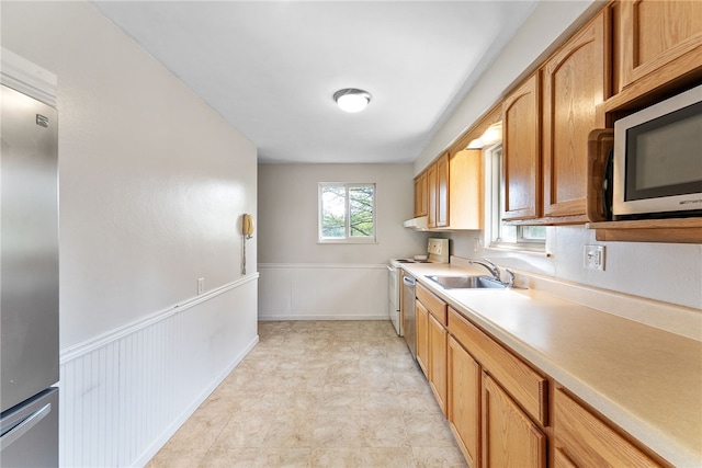 935 Broglie, South Park, PA 15236 - kitchen featuring light countertops, stainless steel appliances, a sink, and a wainscoted wall