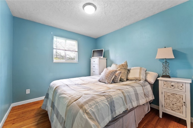 935 Broglie, South Park, PA 15236 - bedroom featuring baseboards, a textured ceiling, and wood finished floors