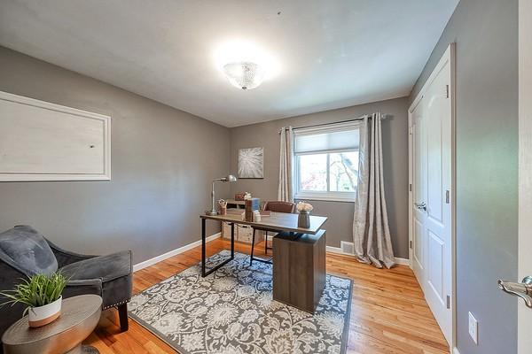 office area featuring baseboards and light wood-style flooring