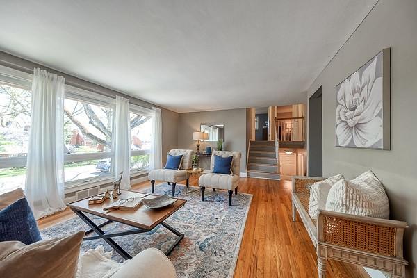 living area with stairway and light wood-style floors