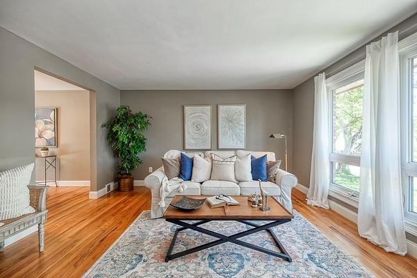 living area with baseboards and light wood-style flooring