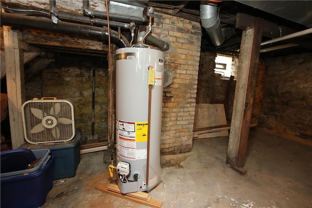 utility room featuring water heater