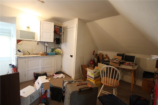 interior space featuring open shelves, light countertops, white cabinetry, and vaulted ceiling